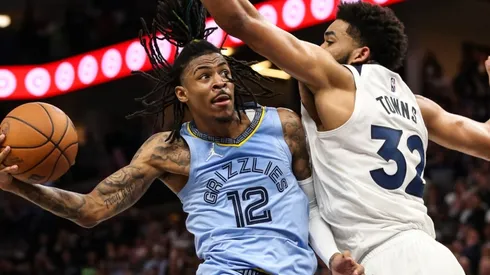 Ja Morant of the Memphis Grizzlies goes up for a shot while Karl-Anthony Towns of the Minnesota Timberwolves defends