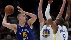Nikola Jokic of the Denver Nuggets is guarded by Nemanja Bjelica and Andre Iguodala of the Golden State Warriors
