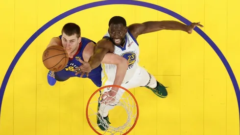 Draymond Green #23 of the Golden State Warriors and Nikola Jokic #15 of the Denver Nuggets