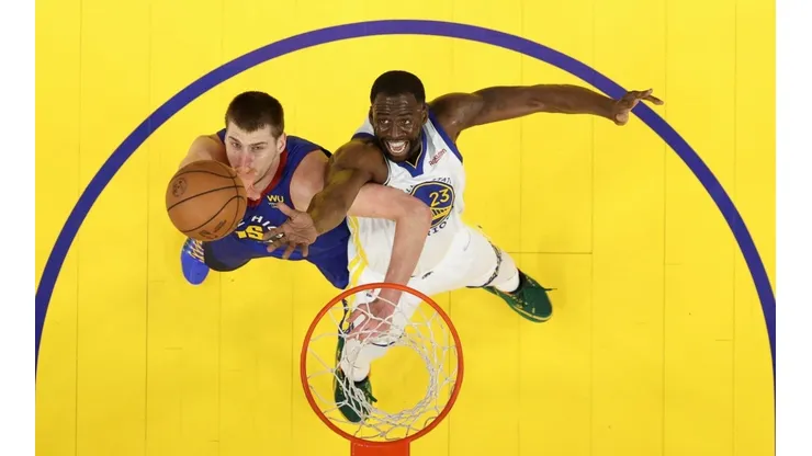 Draymond Green #23 of the Golden State Warriors and Nikola Jokic #15 of the Denver Nuggets