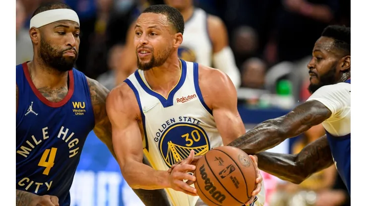 DeMarcus Cousins of the Denver Nuggets and Stephen Curry of the Golden State Warriors
