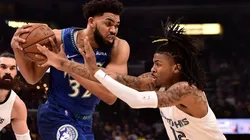 Karl-Anthony Towns of the Minnesota Timberwolves handles the ball against Ja Morant of the Memphis Grizzlies