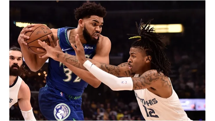 Karl-Anthony Towns of the Minnesota Timberwolves handles the ball against Ja Morant of the Memphis Grizzlies