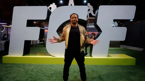 Former Football player Jamal Anderson posing in front of the FCF logo