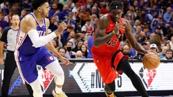 Pascal Siakam of the Toronto Raptors dribbles the ball past Tobias Harris of the Philadelphia 76ers