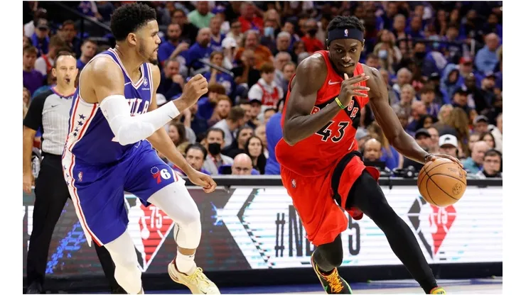 Pascal Siakam of the Toronto Raptors dribbles the ball past Tobias Harris of the Philadelphia 76ers
