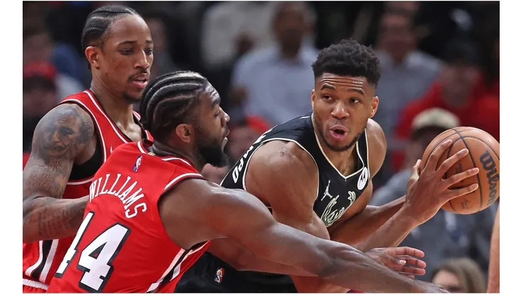 Giannis Antetokounmpo of the Milwaukee Bucks under pressure from DeMar DeRozan and Patrick Williamsof the Chicago Bulls