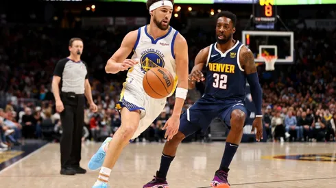 Klay Thompson of the Golden State Warriors drives past Jeff Green of the Denver Nuggets