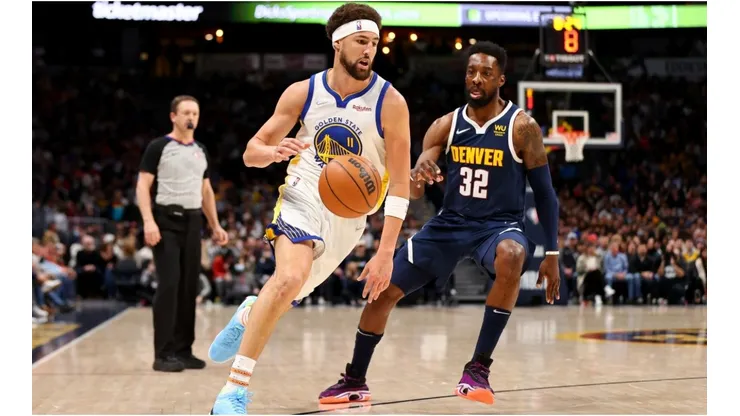Klay Thompson of the Golden State Warriors drives past Jeff Green of the Denver Nuggets