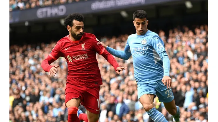 Joao Cancelo of Manchester City is challenged by Mohamed Salah of Liverpool