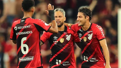 Marlos of Athletico Paranaense celebrates with teammates Matheus Fernandes and Marcinho after scoring