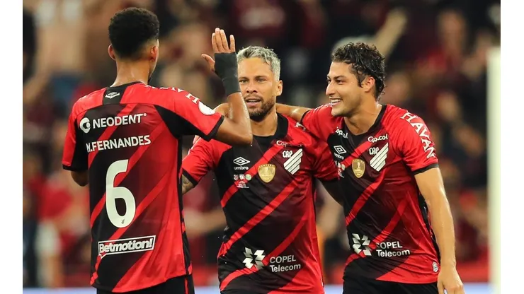 Marlos of Athletico Paranaense celebrates with teammates Matheus Fernandes and Marcinho after scoring