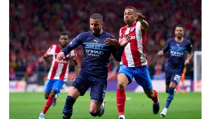 Renan Lodi of Atletico Madrid competes for the ball with Kyle Walker of Manchester City