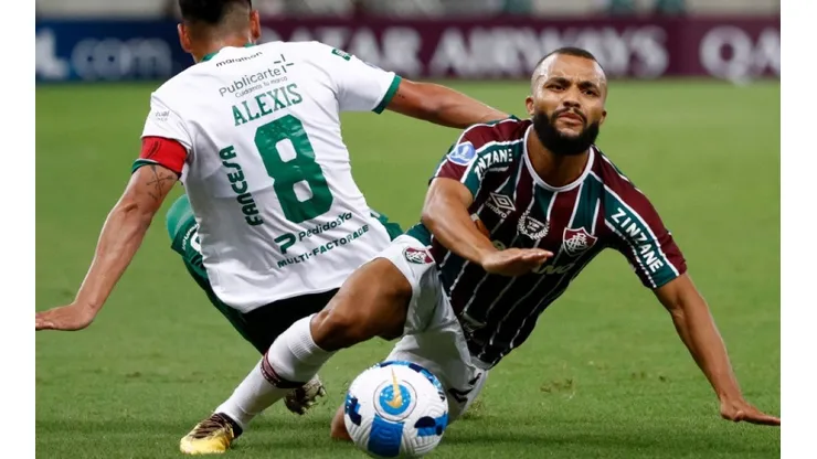 Ribera of Oriente Petrolero fight for ball possession against Xavier of Fluminense