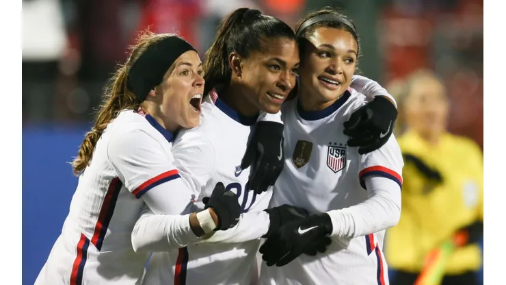 The USWNT players celebrate after scoring a goal