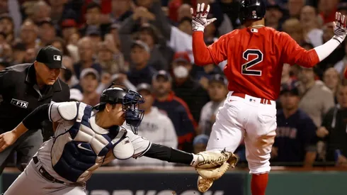 Xander Bogaerts #2 of the Boston Red Sox scores a run past Kyle Higashioka #66 of the New York Yankees