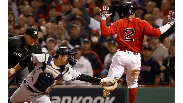 Xander Bogaerts #2 of the Boston Red Sox scores a run past Kyle Higashioka #66 of the New York Yankees
