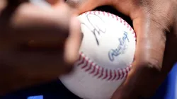 Francisco Lindor signing a baseball