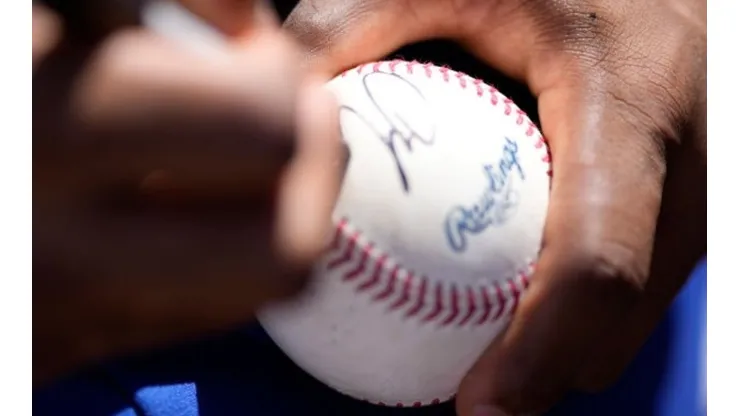 Francisco Lindor signing a baseball