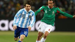 Lionel Messi escapes from Gerardo Torrado in a Argentina vs Mexico match