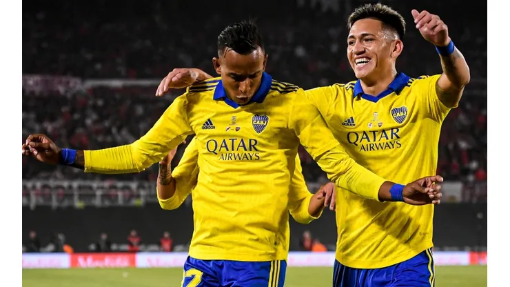 Sebastián Villa and Luis Vázquez celebrating a goal.