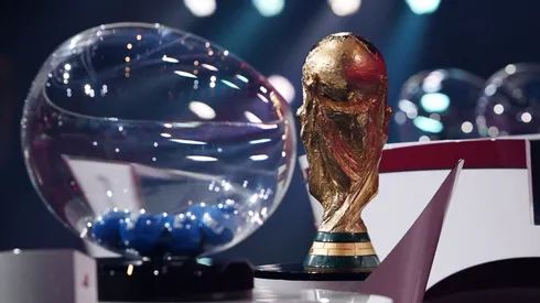 The FIFA World Cup trophy and a draw pot.