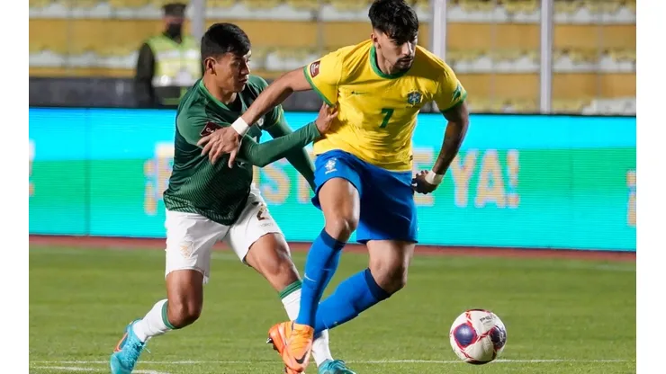 Lucas Paqueta of Brazil fights for the ball with Jose Sagredo of Bolivia.