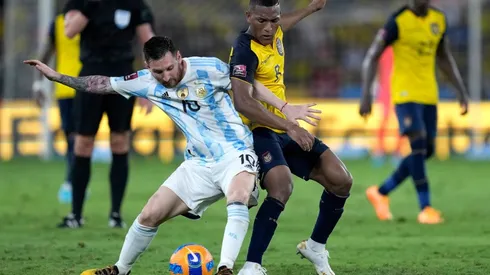 Lionel Messi of Argentina fights for the ball with Carlos Gruezo of Ecuador.