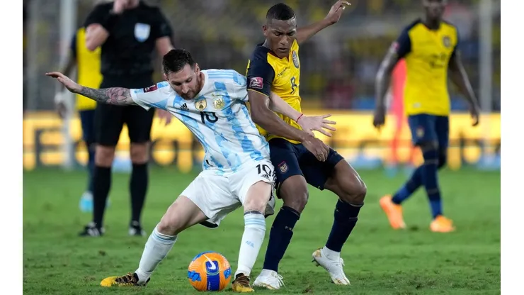 Lionel Messi of Argentina fights for the ball with Carlos Gruezo of Ecuador.