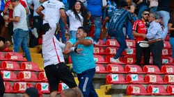 Fans of Atlas and Queretaro fight in the stands during the 9th round match between Queretaro and Atlas