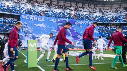 Players of Barcelona and Real Madrid enter the Santiago Bernabeu