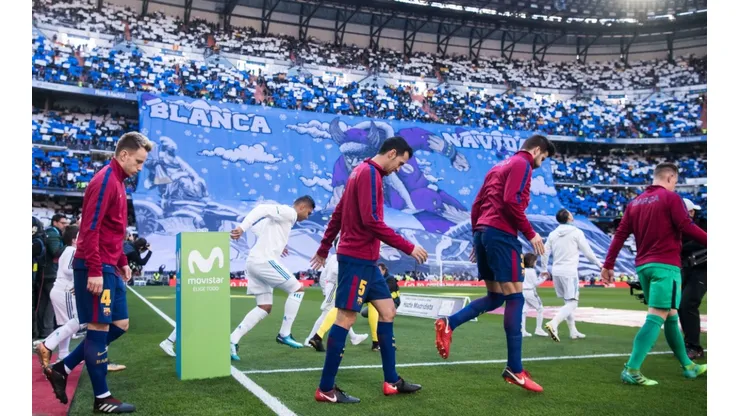 Players of Barcelona and Real Madrid enter the Santiago Bernabeu