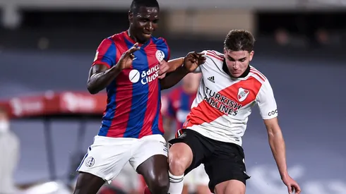 Cristian Zapata of San Lorenzo (left) protects the ball against Julian Alvarez of River Plate.