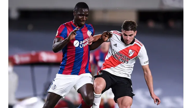Cristian Zapata of San Lorenzo (left) protects the ball against Julian Alvarez of River Plate.