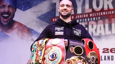 Josh Taylor stands with his titles