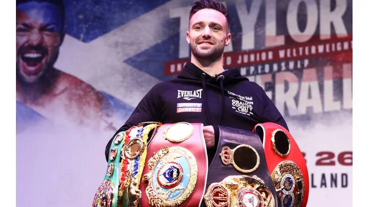 Josh Taylor stands with his titles