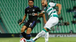 Mathieu Choiniere (L) of Montreal fights for the ball with Matheus Doria (R) of Santos