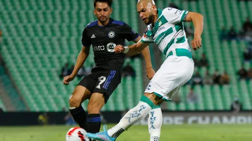 Mathieu Choiniere (L) of Montreal fights for the ball with Matheus Doria (R) of Santos