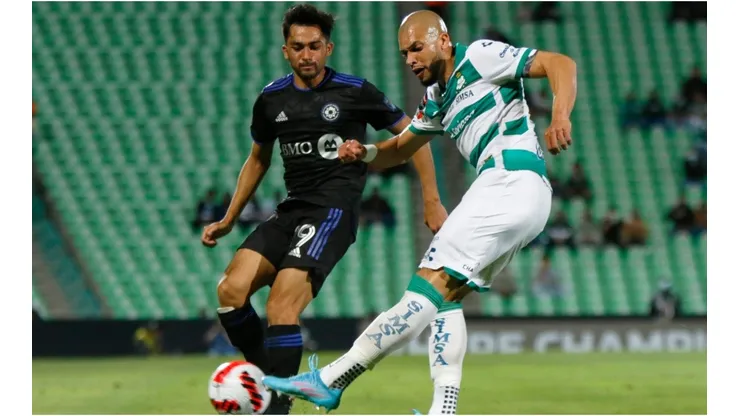 Mathieu Choiniere (L) of Montreal fights for the ball with Matheus Doria (R) of Santos