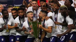 Paul Arriola #7 of United States and Sebastian Lletget #17 lifts the trophy to celebrate with his teammates after winning the CONCACAF Gold Cup 2021