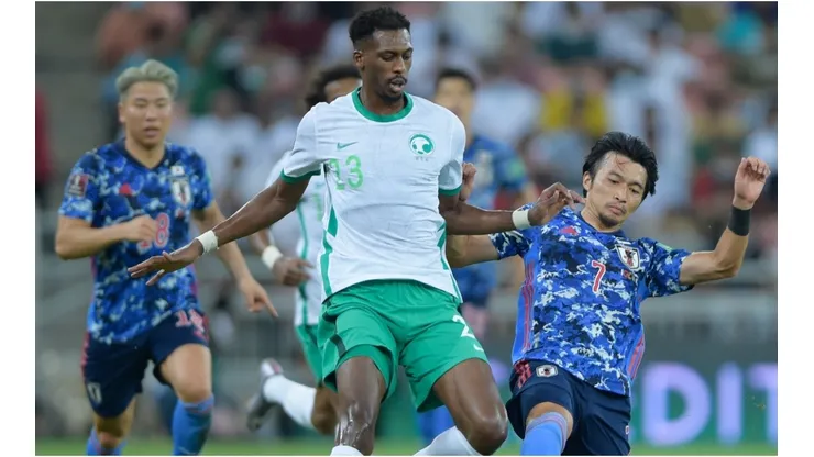 Mohamed Kanno of Saudi Arabia is tackled by Gaku Shibasaki of Japan during a Qualifier match