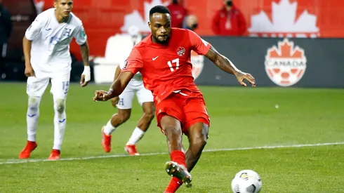 Cyle Larin #17 of Canada scores a penalty during a 2022 World Cup Qualifying match against Honduras.