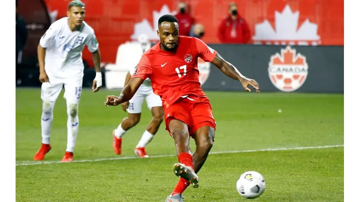 Cyle Larin #17 of Canada scores a penalty during a 2022 World Cup Qualifying match against Honduras.