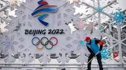 A volunteer cleans a sculpture about Beijing 2022 Winter Olympics