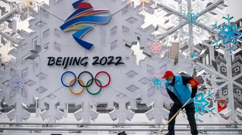 A volunteer cleans a sculpture about Beijing 2022 Winter Olympics