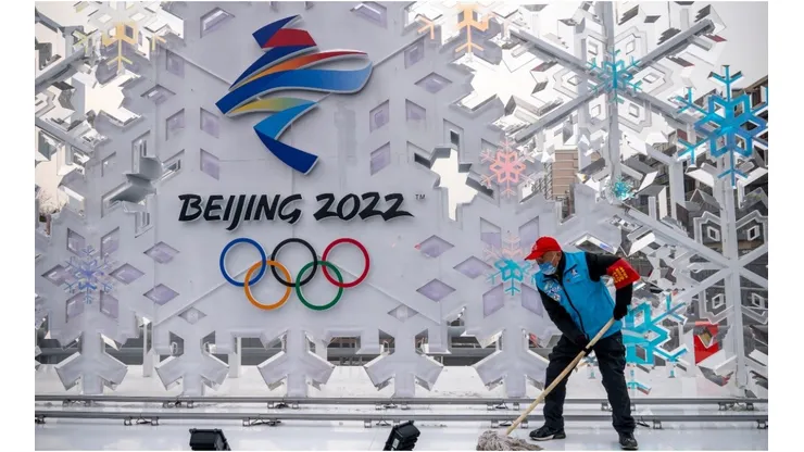 A volunteer cleans a sculpture about Beijing 2022 Winter Olympics