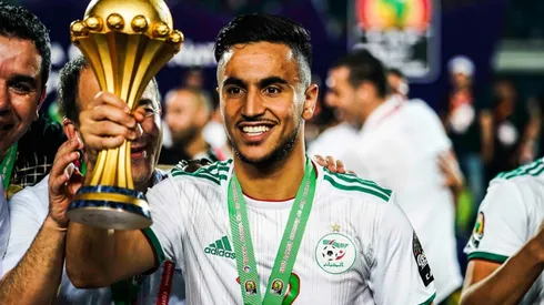 Adam Ounas of Algeria celebrates with the 2019 Africa Cup of Nations Trophy