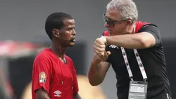 Tunisia head coach Mondher Kebaier points his watch to complain to Zambian referee Janny Sikazwe for ending the Mali vs Tunisia game prematurely.