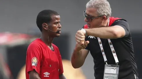Tunisia head coach Mondher Kebaier points his watch to complain to Zambian referee Janny Sikazwe for ending the Mali vs Tunisia game prematurely.