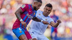 Memphis Depay of FC Barcelona and Casemiro of Real Madrid CF battle for the ball.
